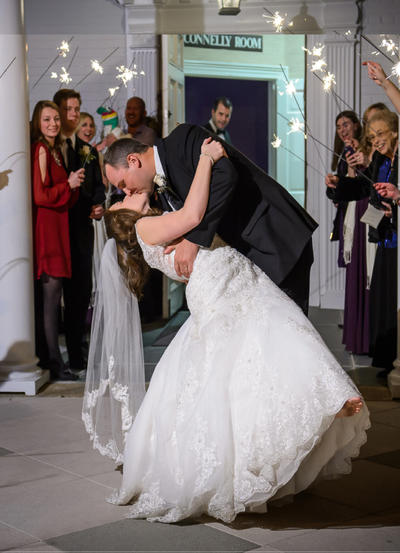Bride and groom kissing in front of the Connelly Room