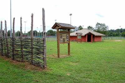 Field with Native American building