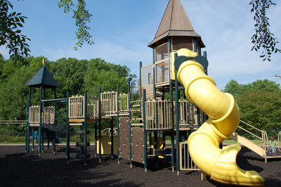 Yellow tube slide on play structure