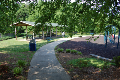 Path next to picnic shelter and play structure