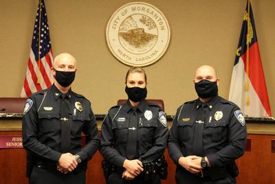 An officer with Chief Lowdermilk and Major Lander after being sworn in